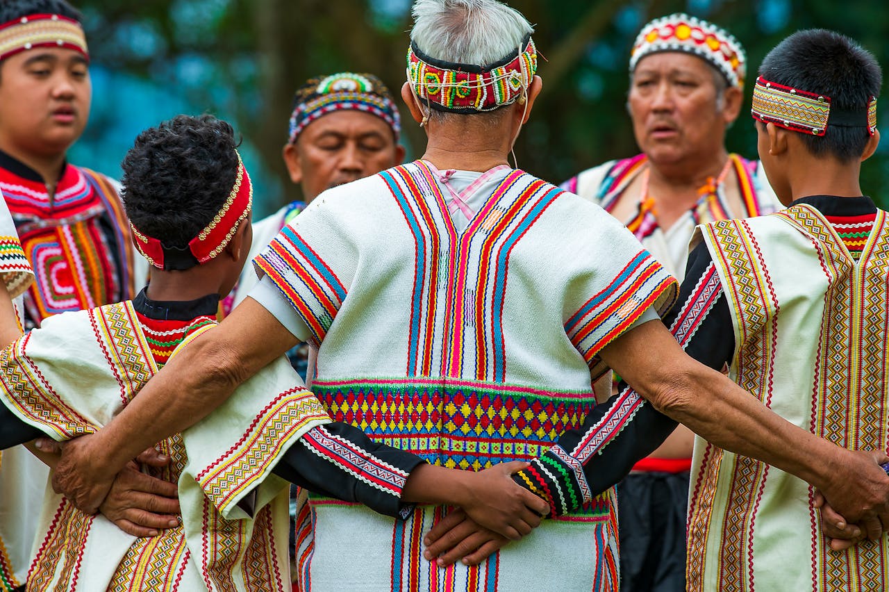 A group of men in traditional Taiwanese clothing embracing in a cultural gathering.
